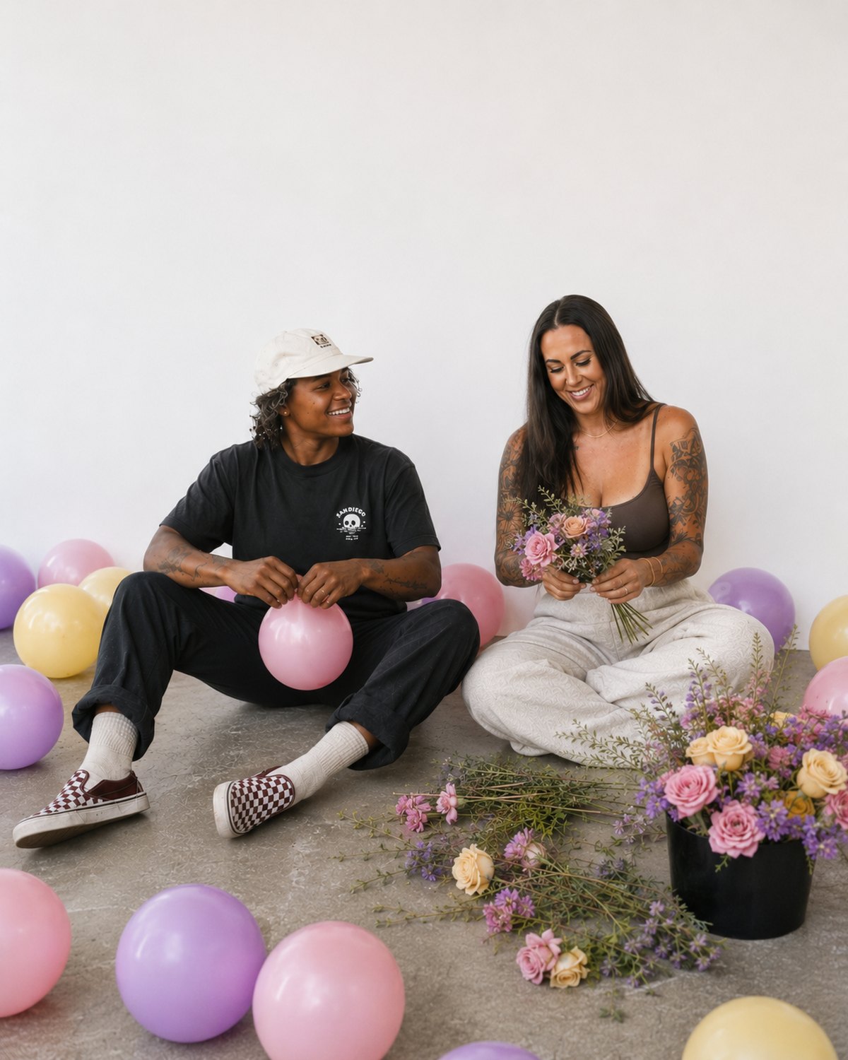 Morgan and Summer, founders of MS Creative Events, building balloon installs and arranging flowers
