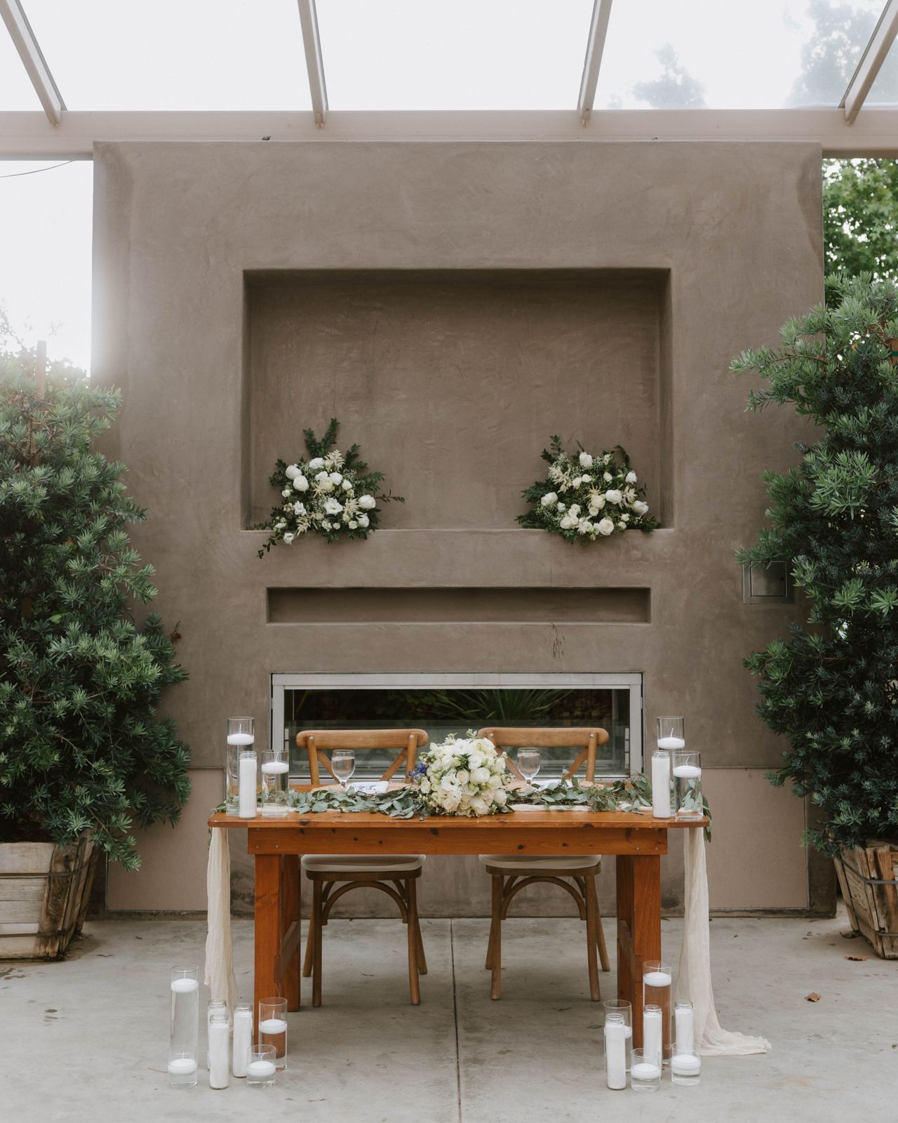 Fireplace mantel greenery with a sweetheart table below