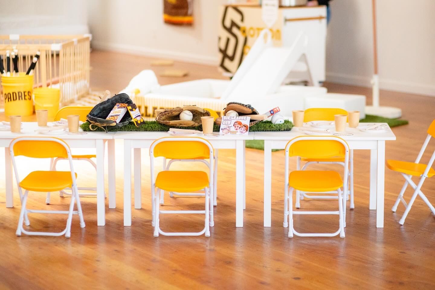Kids party table with yellow folding chairs set for a tennis themed celebration