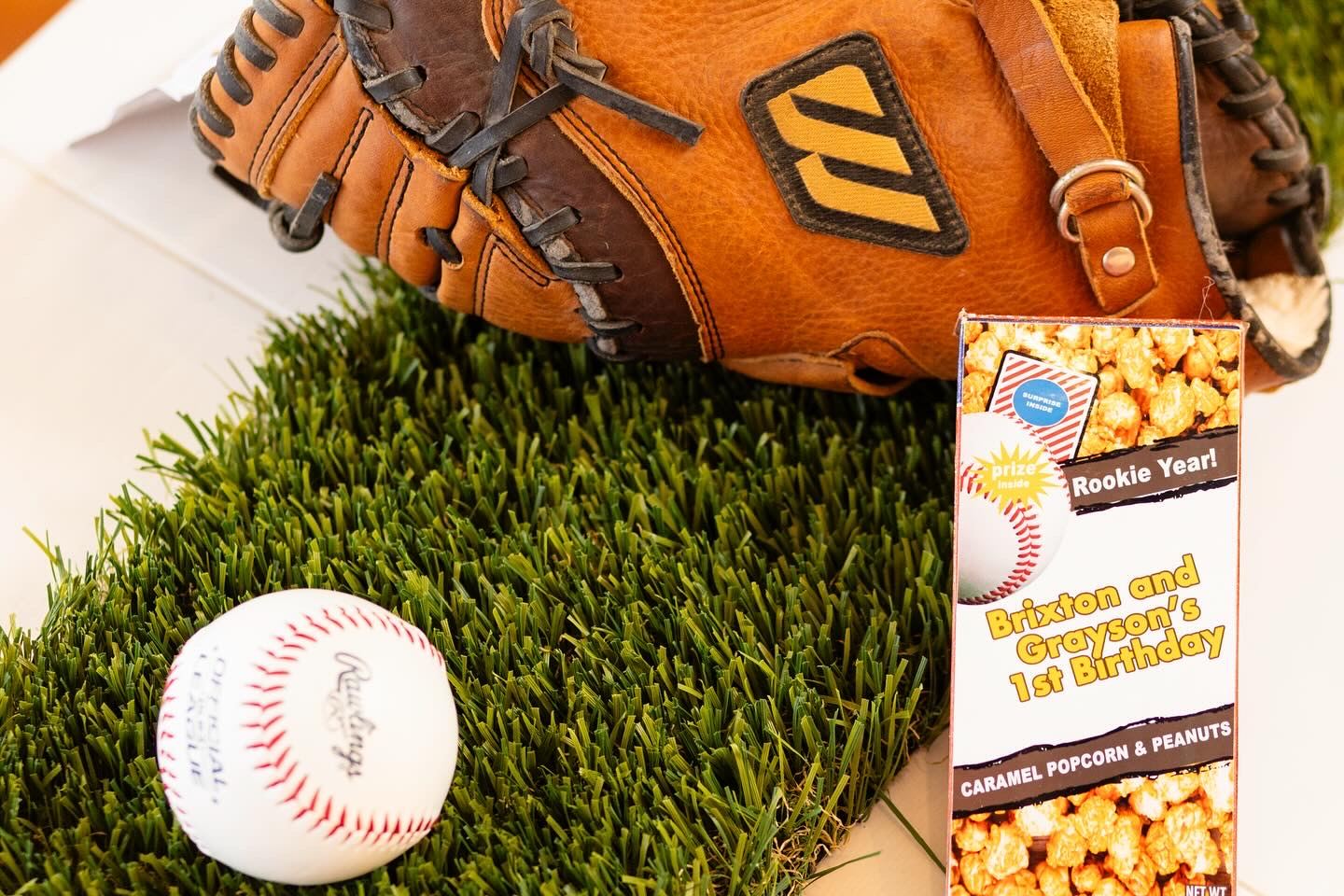 Baseball glove and popcorn party favors on turf