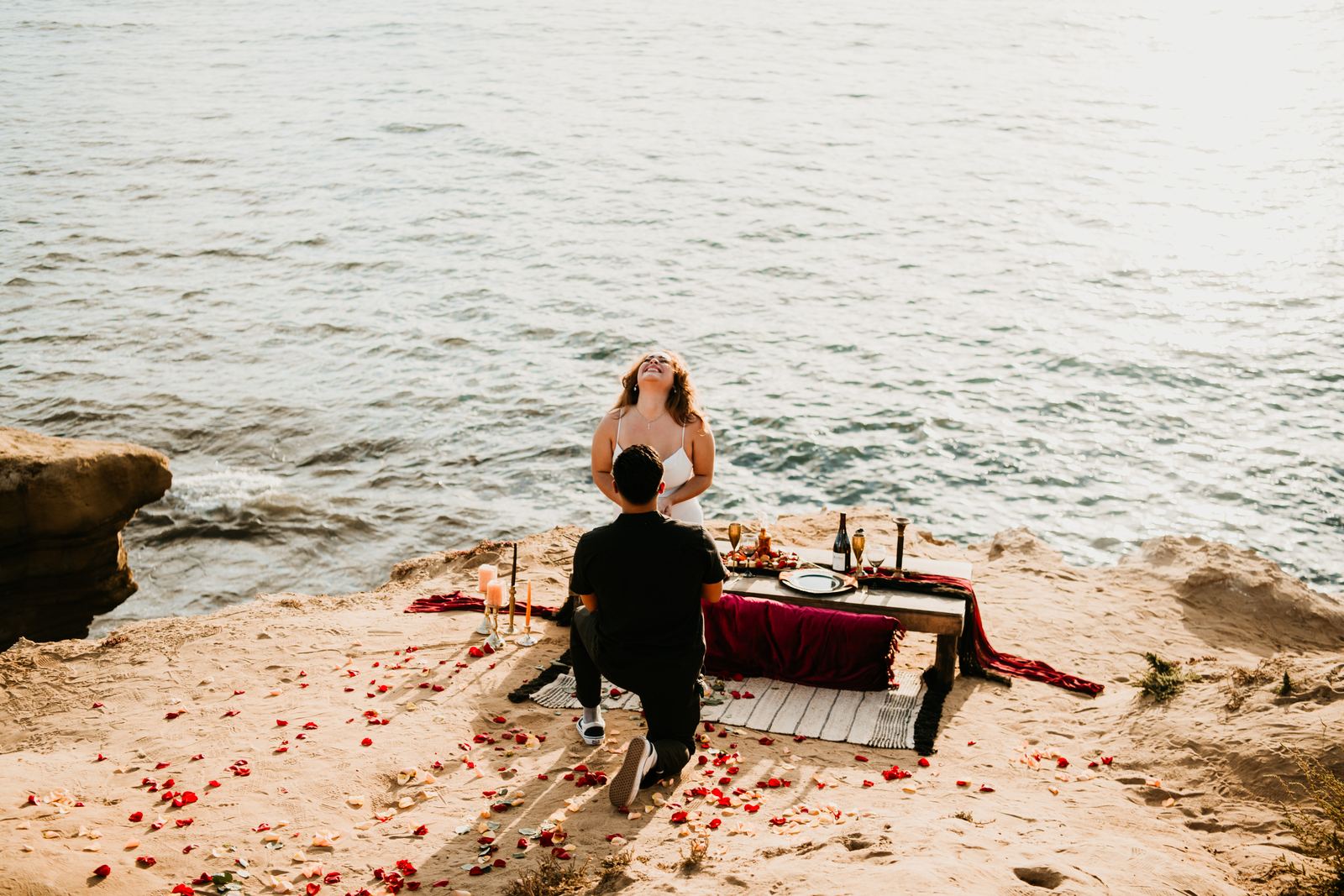 Beach picnic setup on the bluffs at sunset