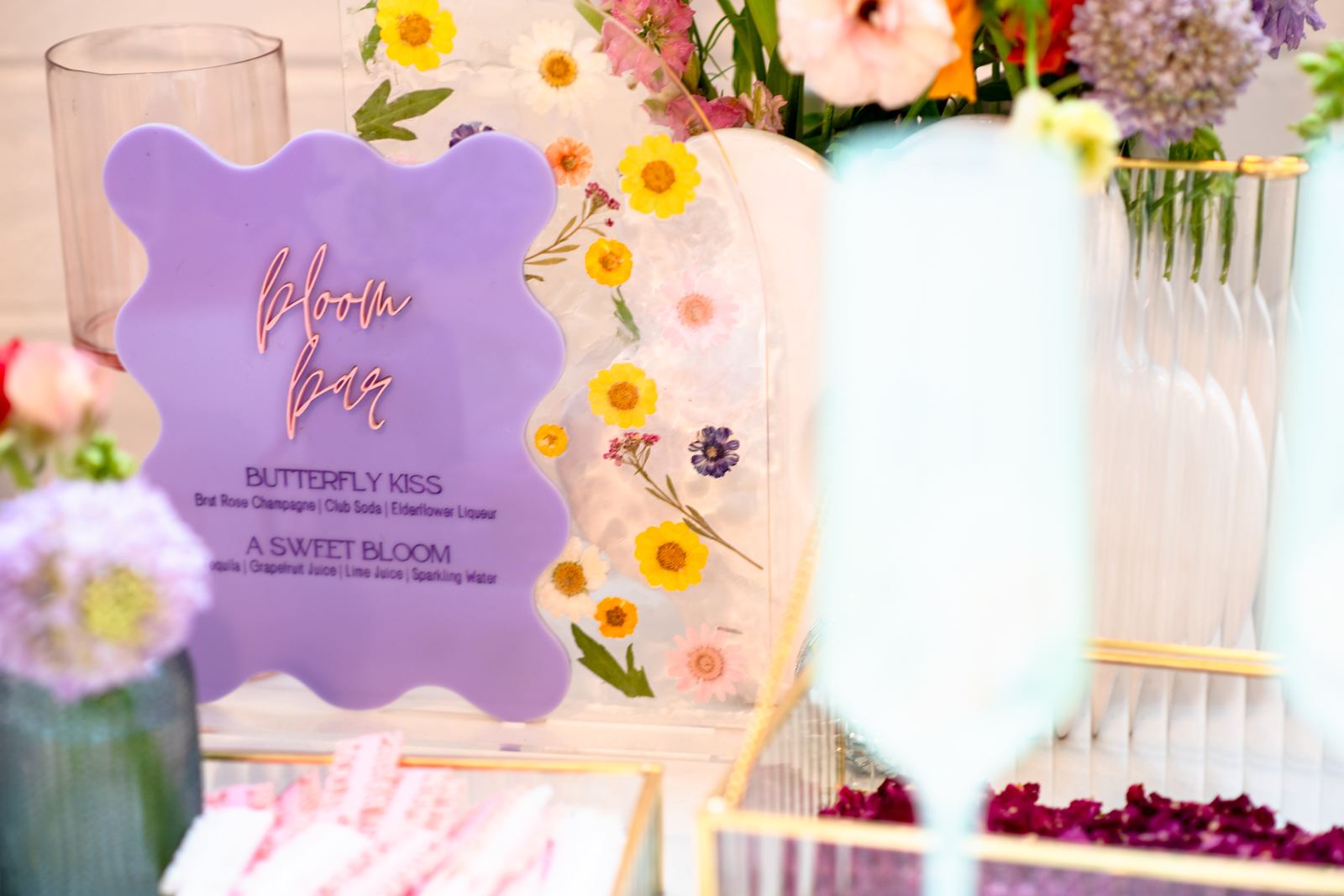 Pressed flower glassware details at a bloom bar