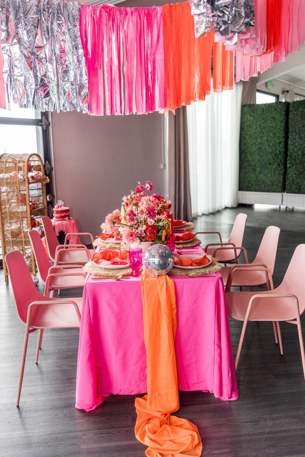 Event room filled with pink floral installs and fringe