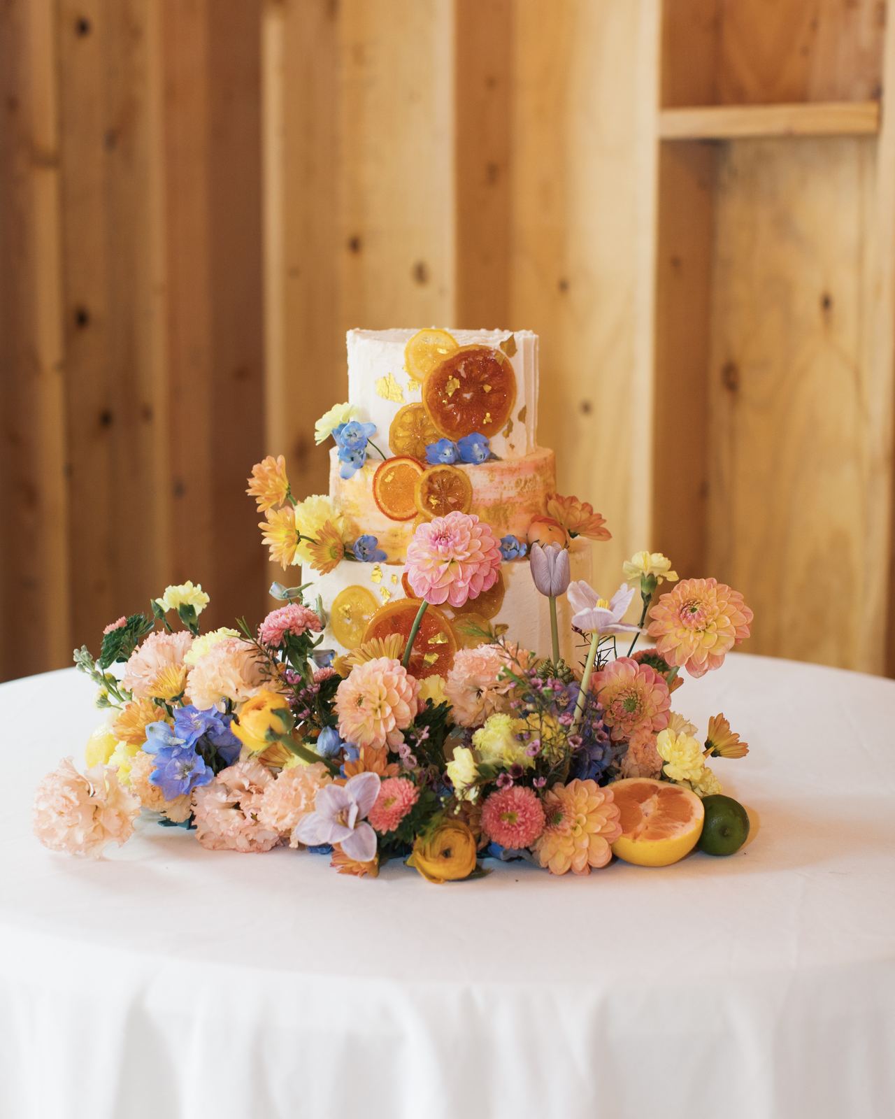 Wedding cake covered in colorful fresh florals