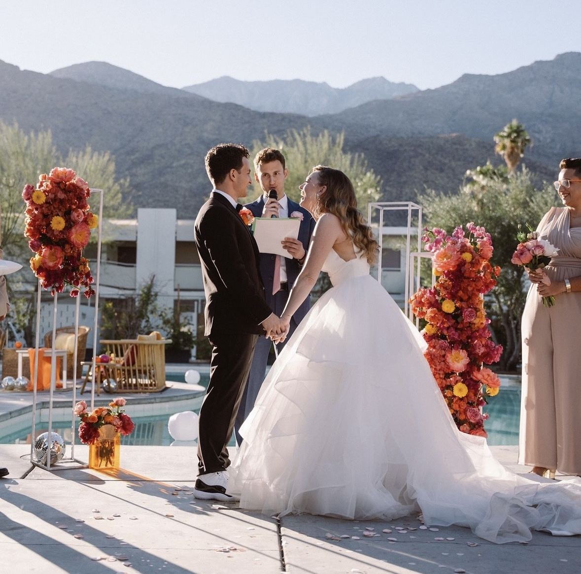 Poolside wedding ceremony with mountain views