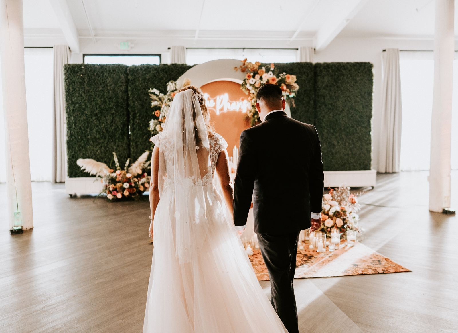Wedding party under an indoor floral arch