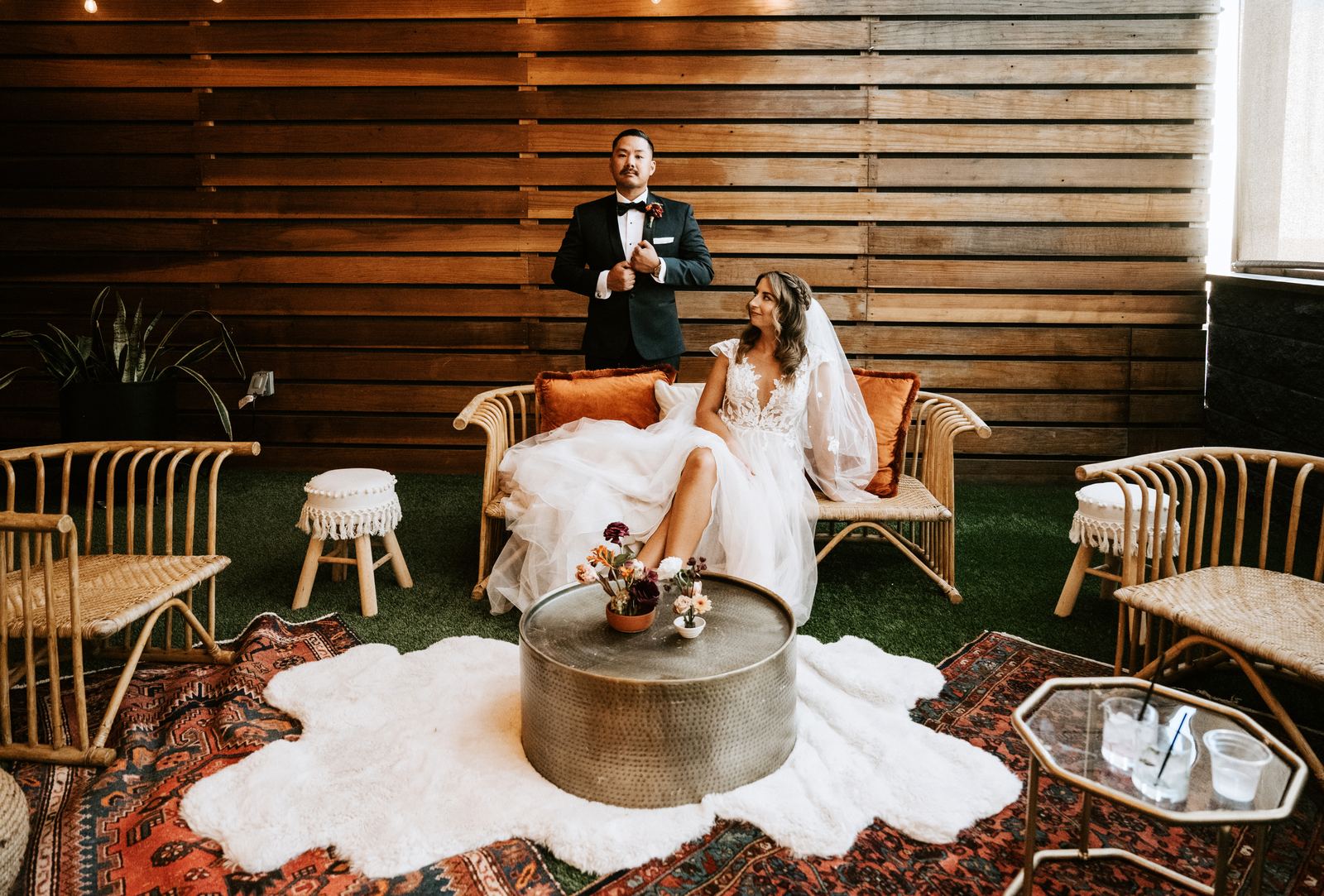 Arched backdrop with florals behind a sweetheart lounge