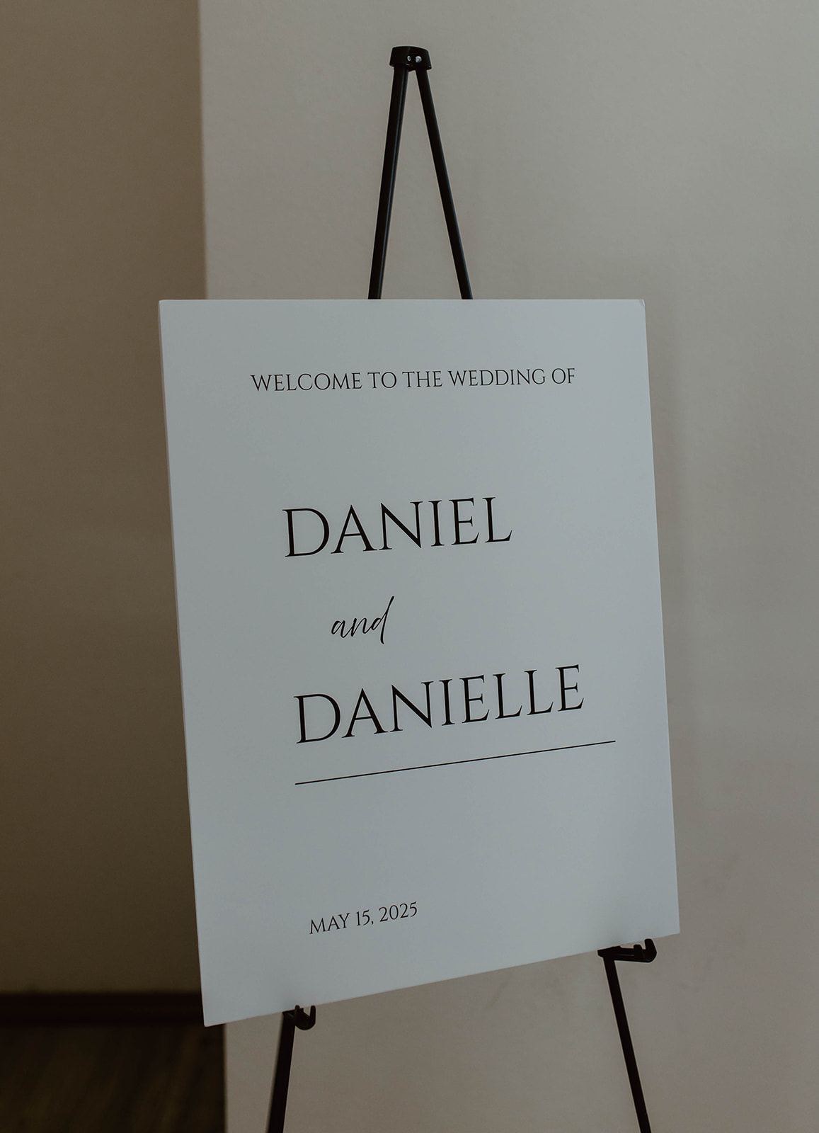 Welcome sign on an easel at a wedding entrance