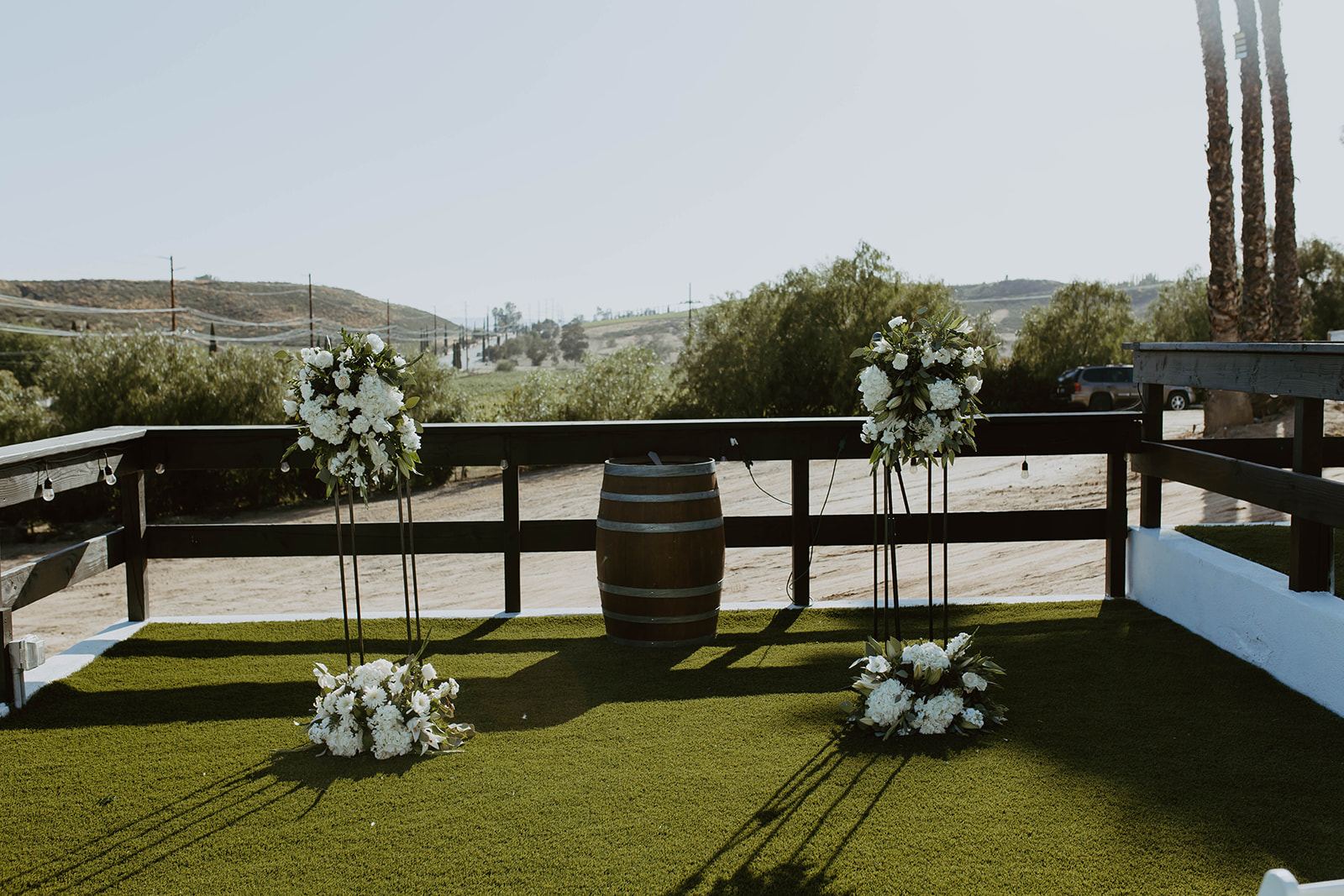 White floral arrangements marking the ceremony space