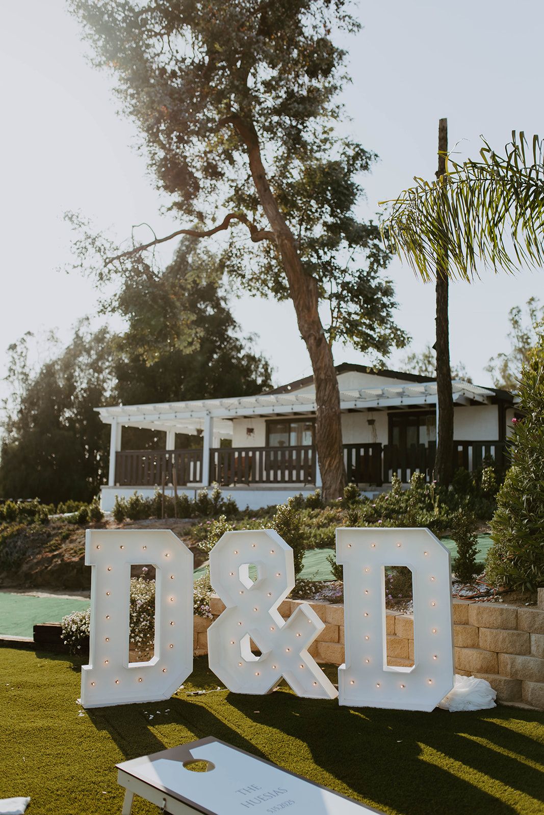 Marquee initials on the lawn at an outdoor wedding