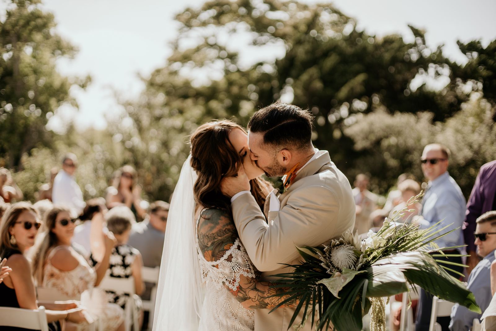 Couple kissing at an outdoor garden ceremony