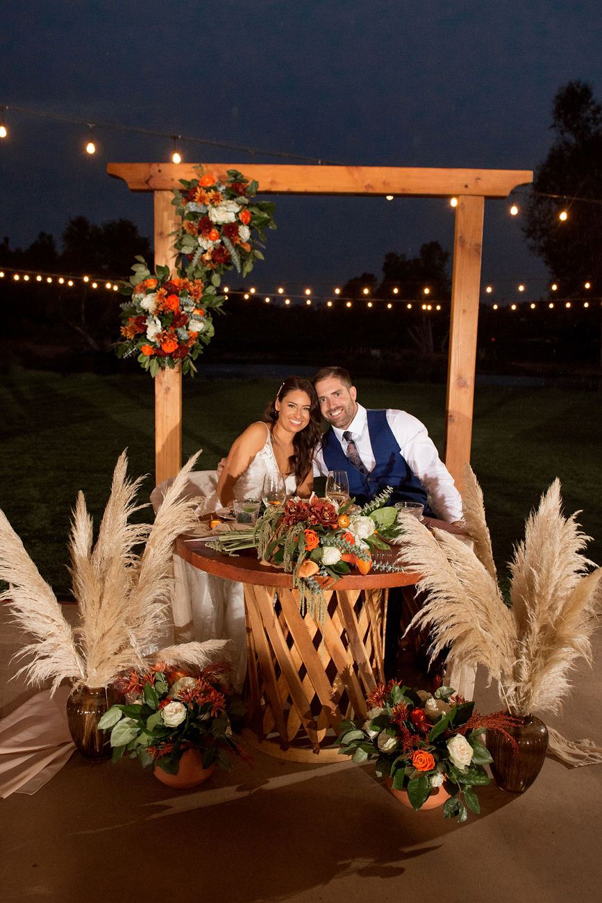 Sweetheart arch with pampas grass under string lights
