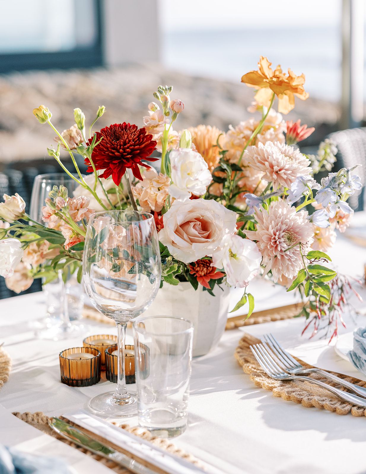 Close up of a woven charger with dahlias and blue napkin