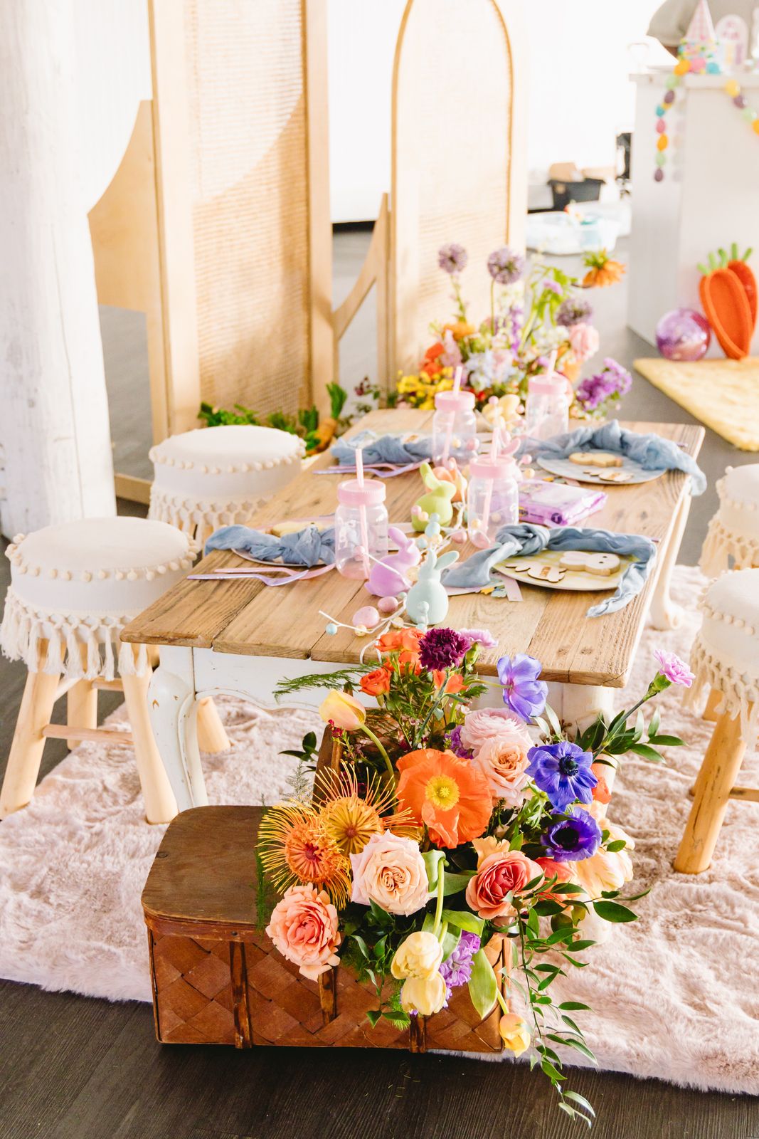 Kids Easter table with colorful florals and themed place settings