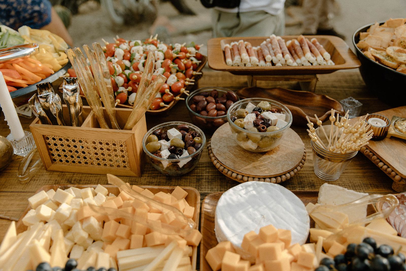Loaded grazing table with woven baskets and boards