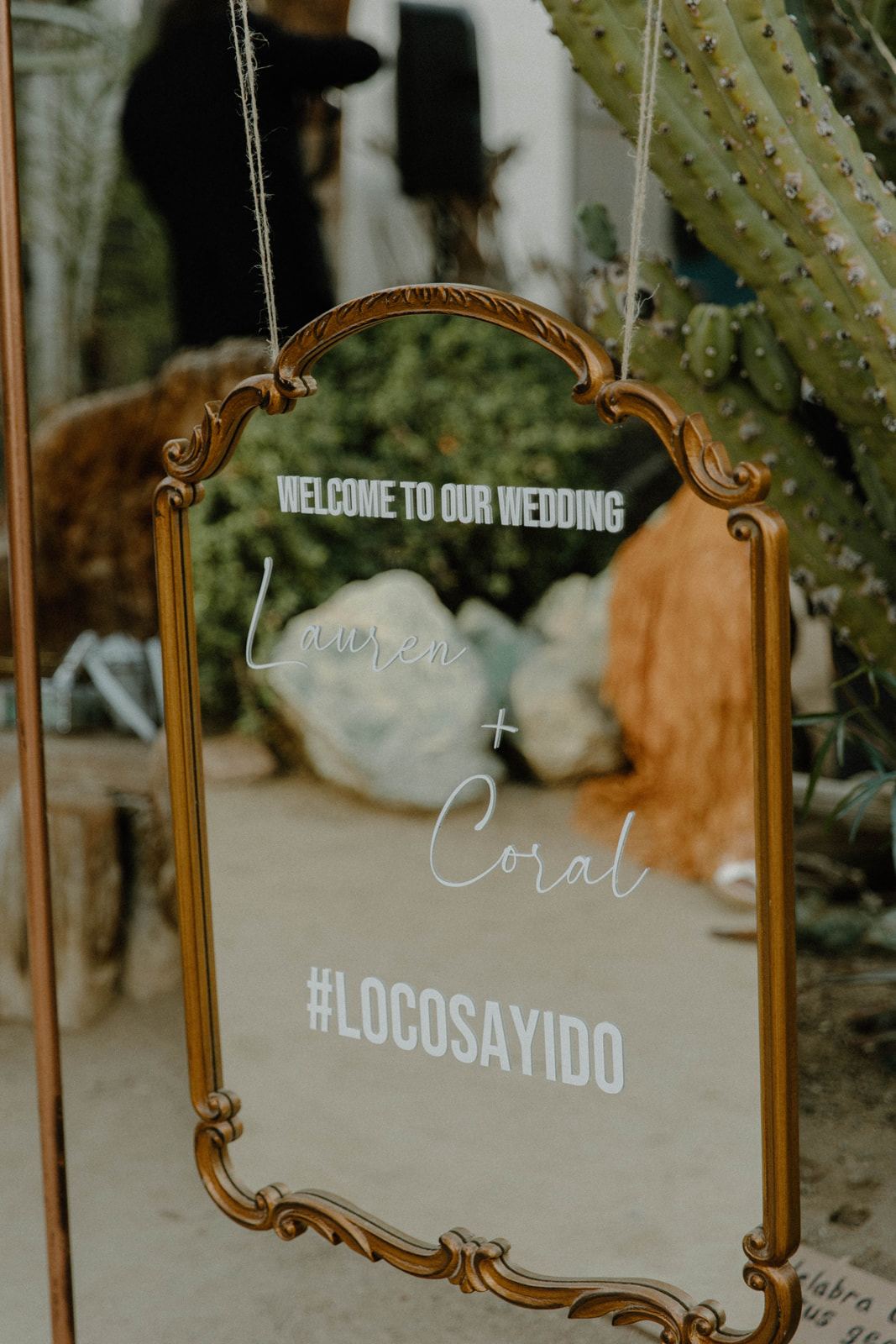 Vintage mirror turned welcome sign at a desert wedding