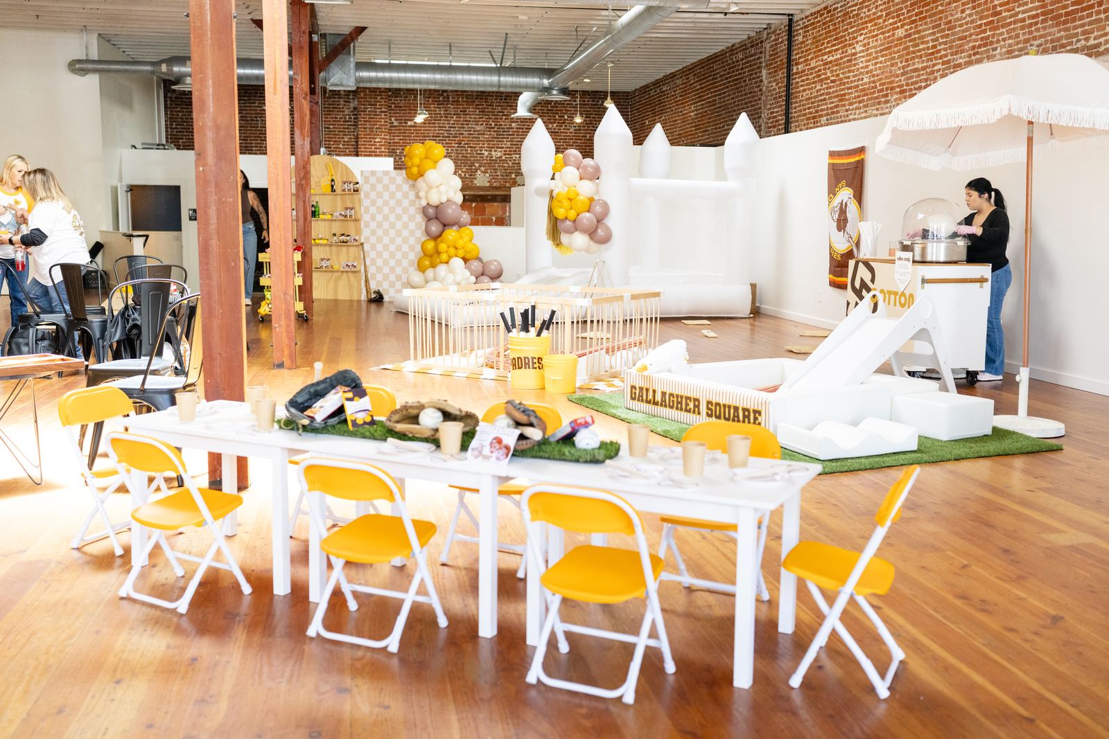 Baseball themed first birthday party room with bounce castle
